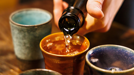 Sake being poured into a sake cup
