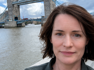 Wendy Harpur, a white female with short brown hair, stood infront of Tower Bridge in London